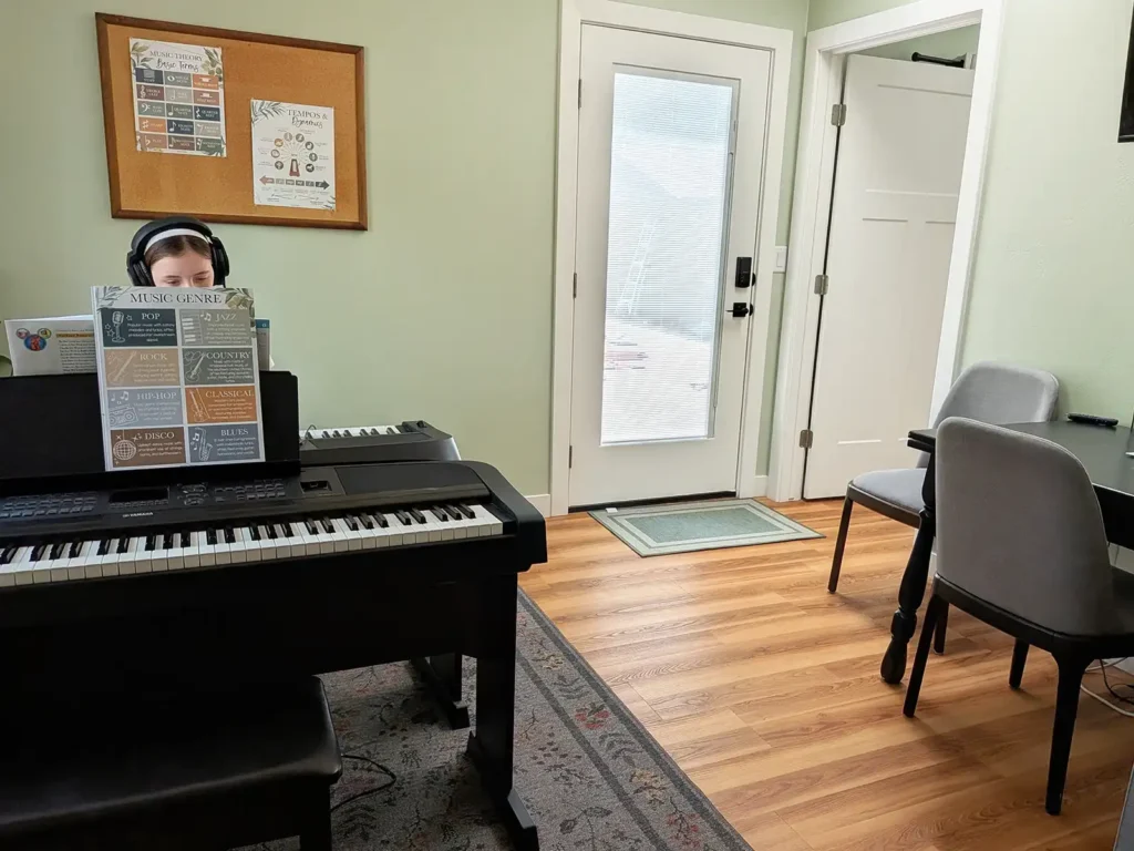Child taking piano lessons in piano studio
